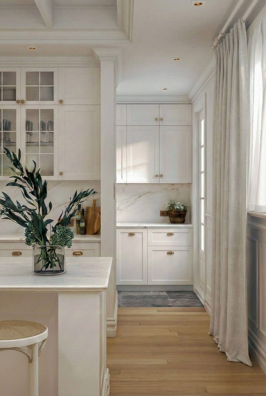 Entrance to butler's pantry with marble splashback and white cabinetry.