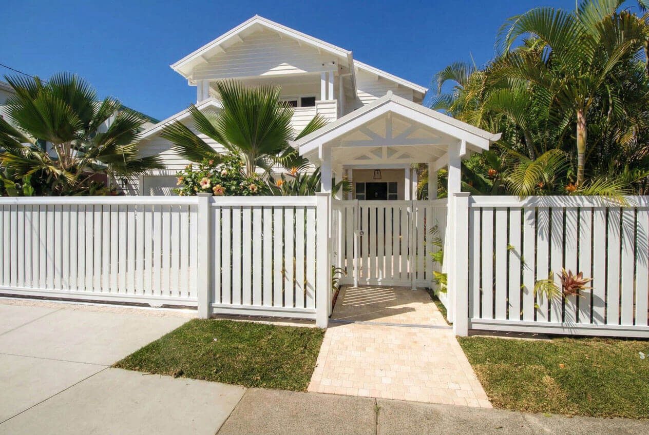 Contemporary Hamptons style facade Mermaid Beach with white weatherboards and gables.