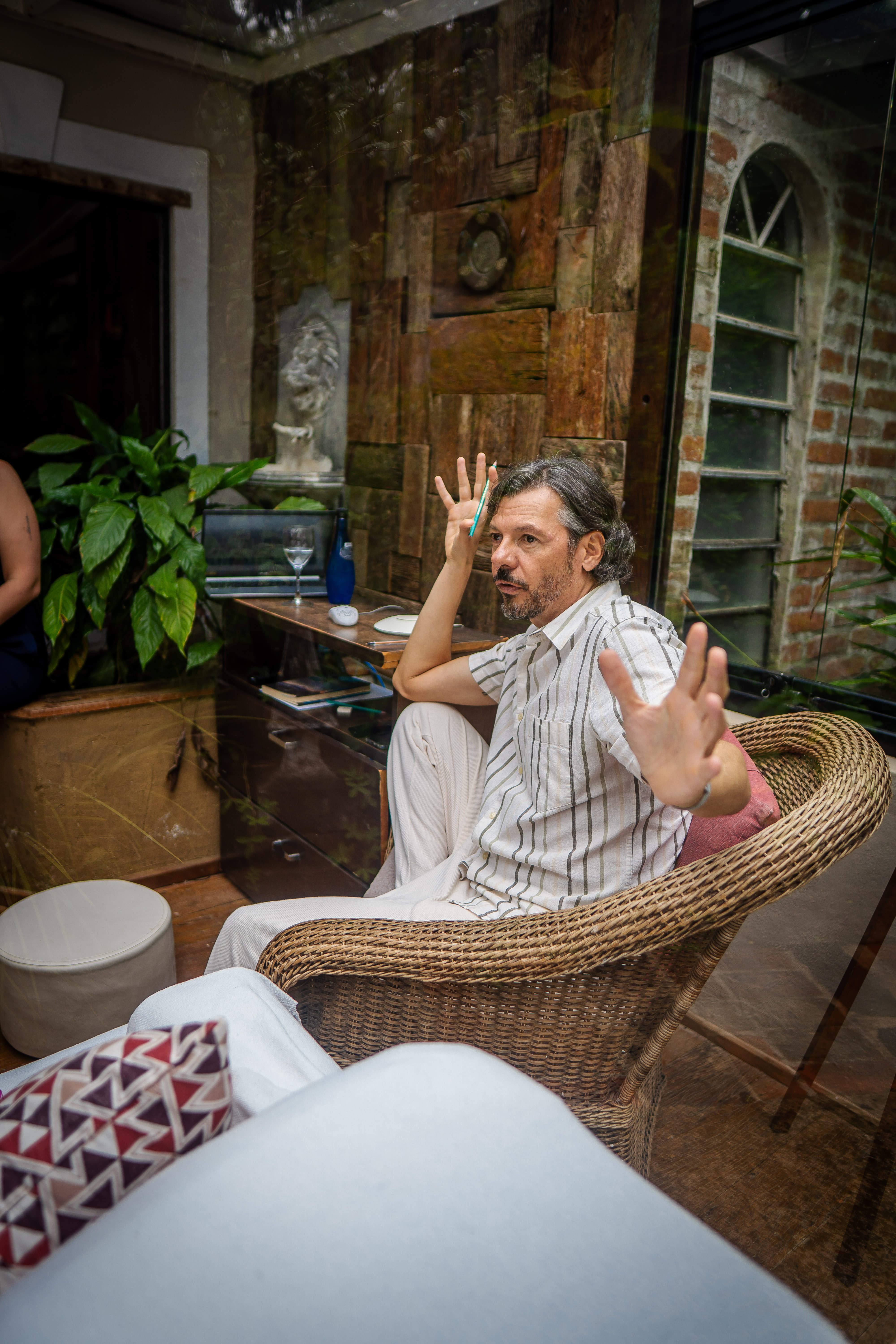 Paul is seated and using a hand gesture while speaking during an emotional regulation workshop.