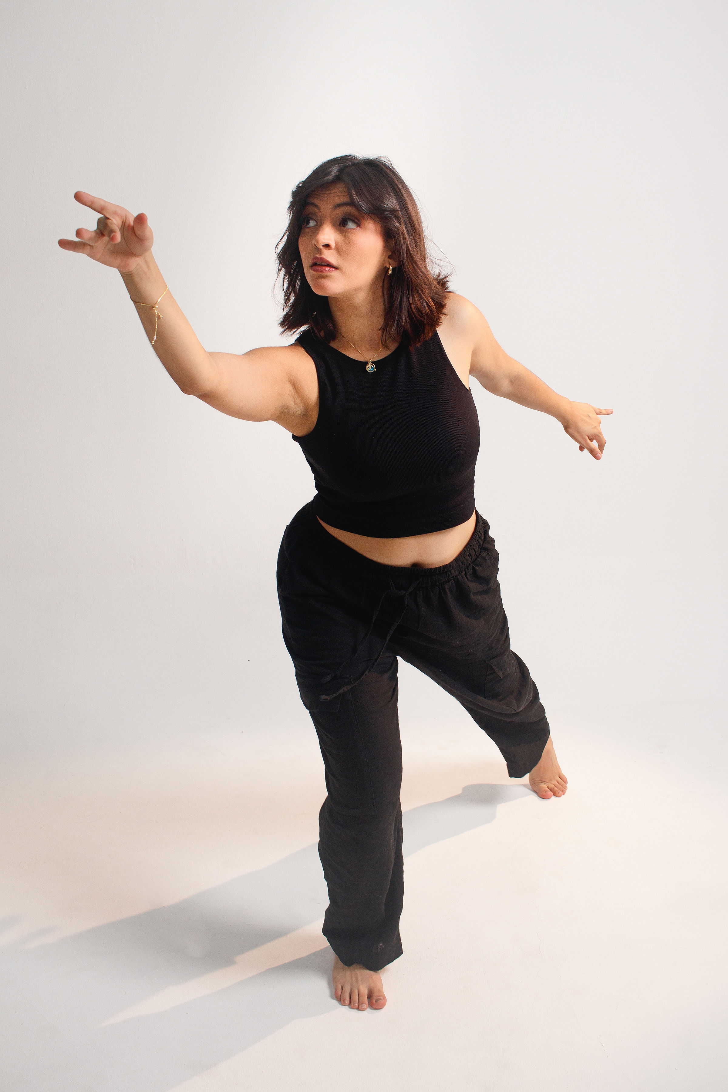 A woman pointing to one corner of a room