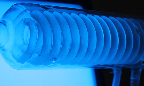 Stress-o-Stat (2011), close up of glass condenser filled with fluorescent bacteria, Techfest 2012, IIT Bombay, January 2012