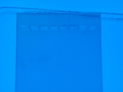 A gel seen with the naked eye on a UV-transilluminator. We are unable to see the DNA even though it is there. By using a