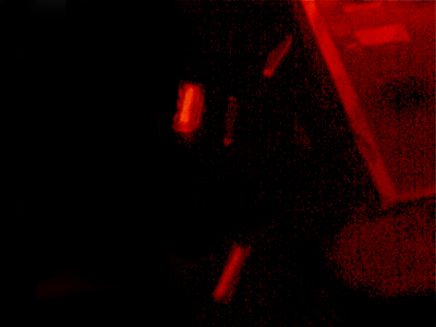 A piece of gel seen through an orange filter. Gel bands containing the DNA fragments have been physically cut out from t