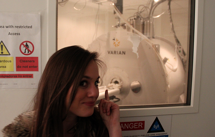 Margherita Cinti pointing out the  MRI (Magnetic Resonance Imaging) scanner.  