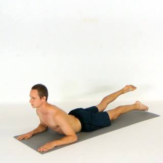 Sphinx pose leg flutters