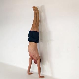 Wall handstand heel pulls