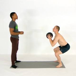 Partner squat overhead ball throw