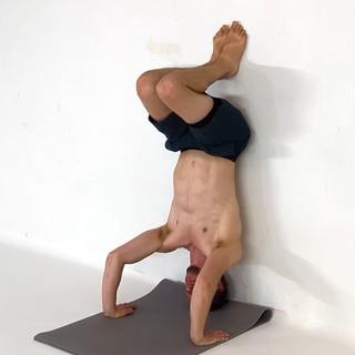 Wall tuck tripod headstand