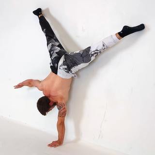 Wall straddle one-arm handstand