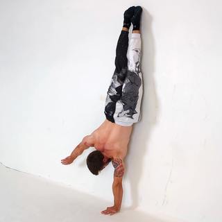 Wall one-arm handstand