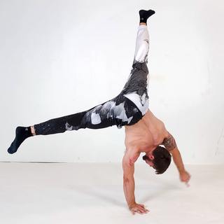 Straddle one-arm handstand fingertip tap
