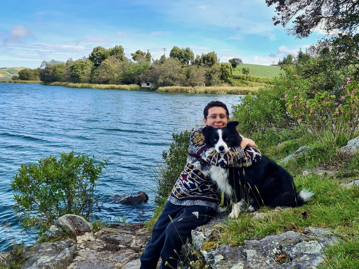Camilo and Loki in a lake in Boyaca, loki is a border collie.