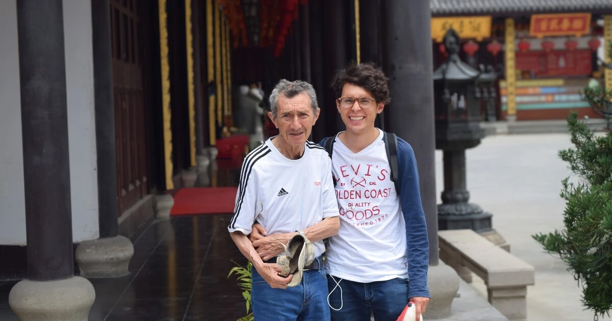 Camilo in china with his grandfather smiling.
