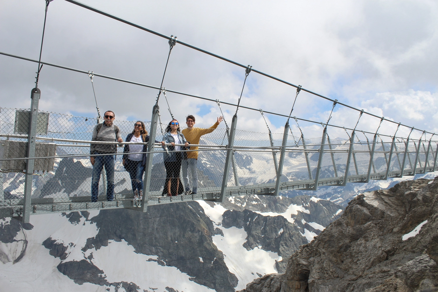 Camilo and his familiy crossing a cable bridge in some mountains near Germany.