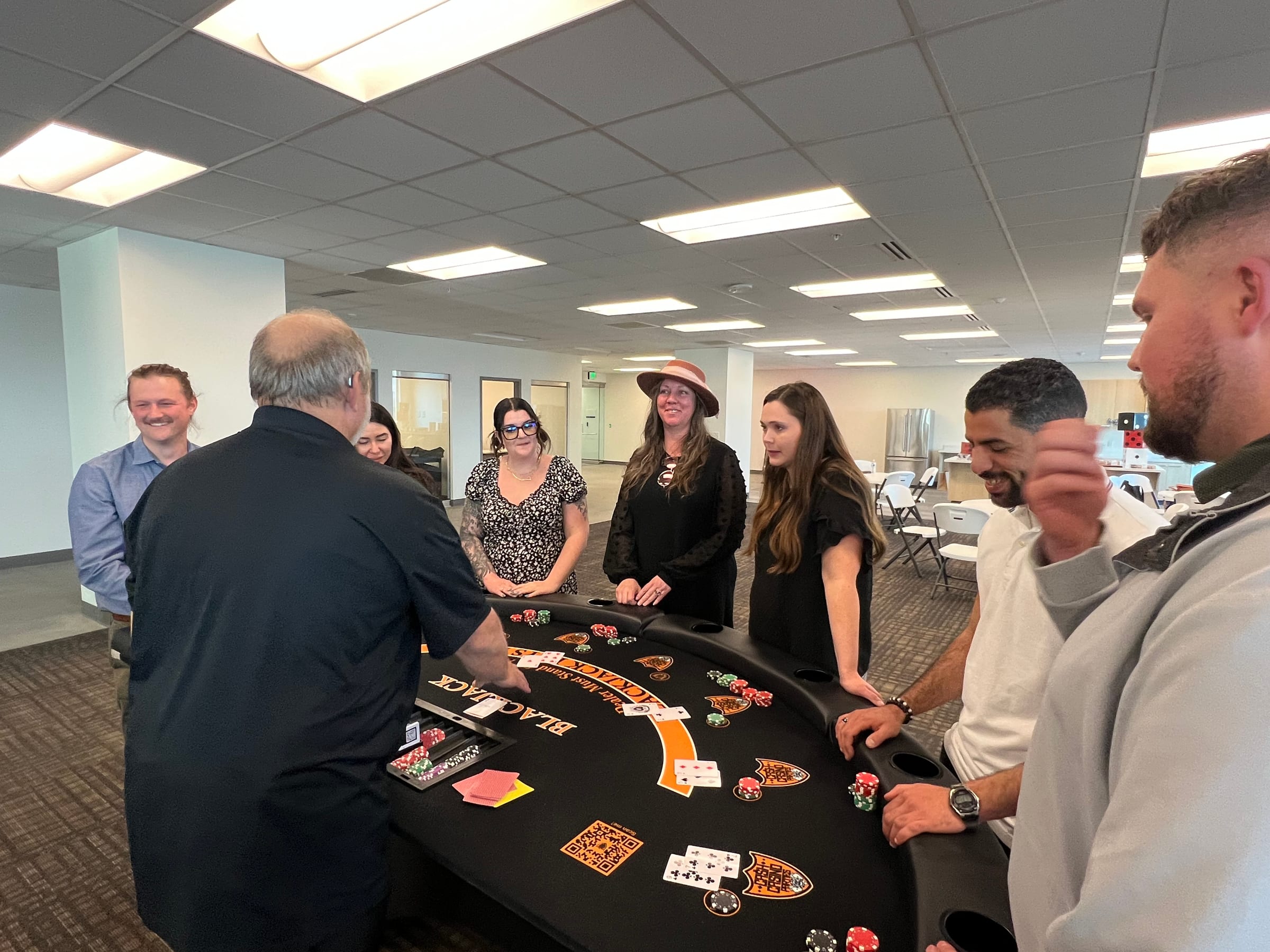 Casino tables and guests at PACS Casino Night, a corporate casino party in Northern Utah