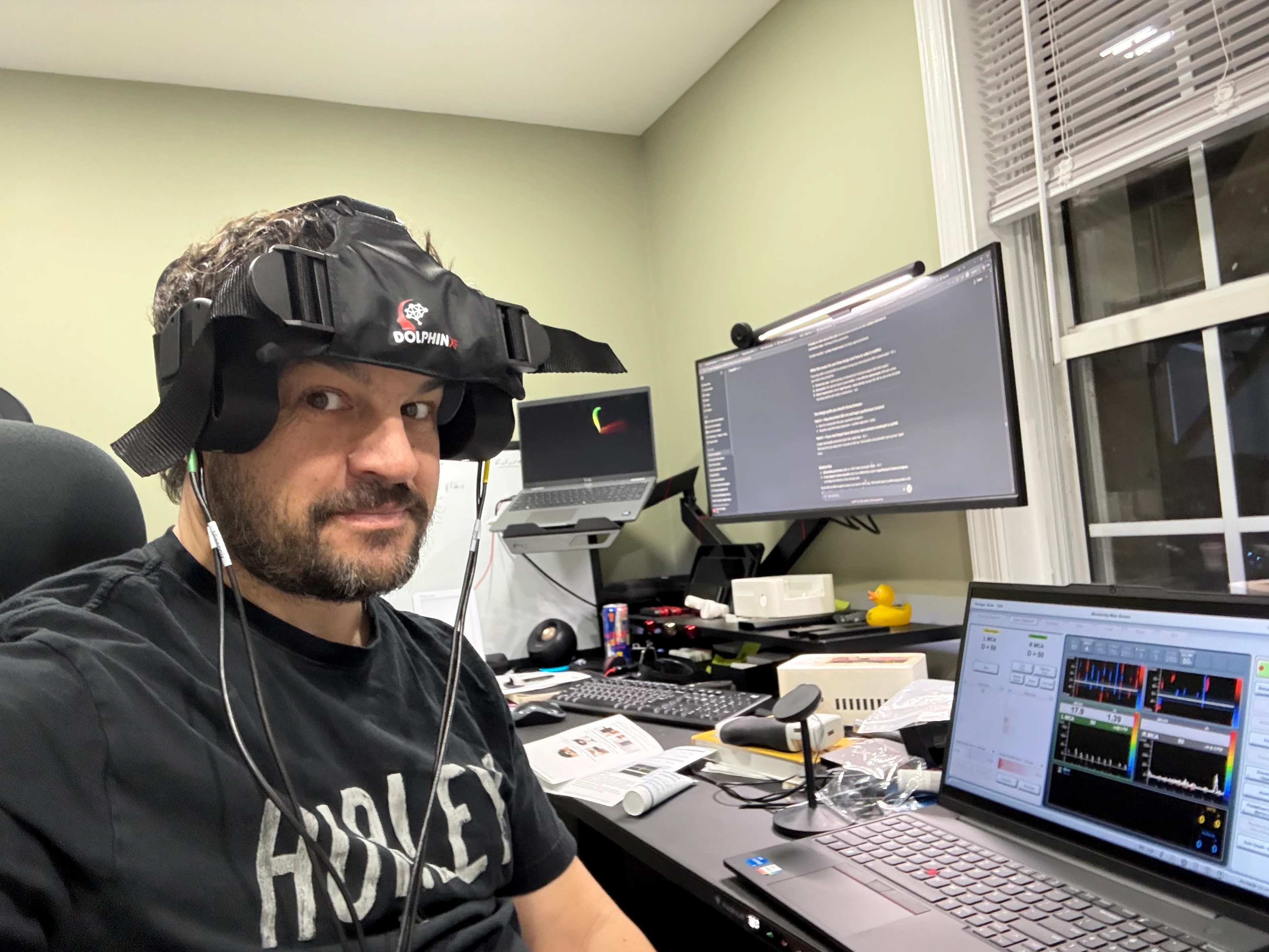 Kevin Horrigan wearing his headset prototype while seated at his desk.