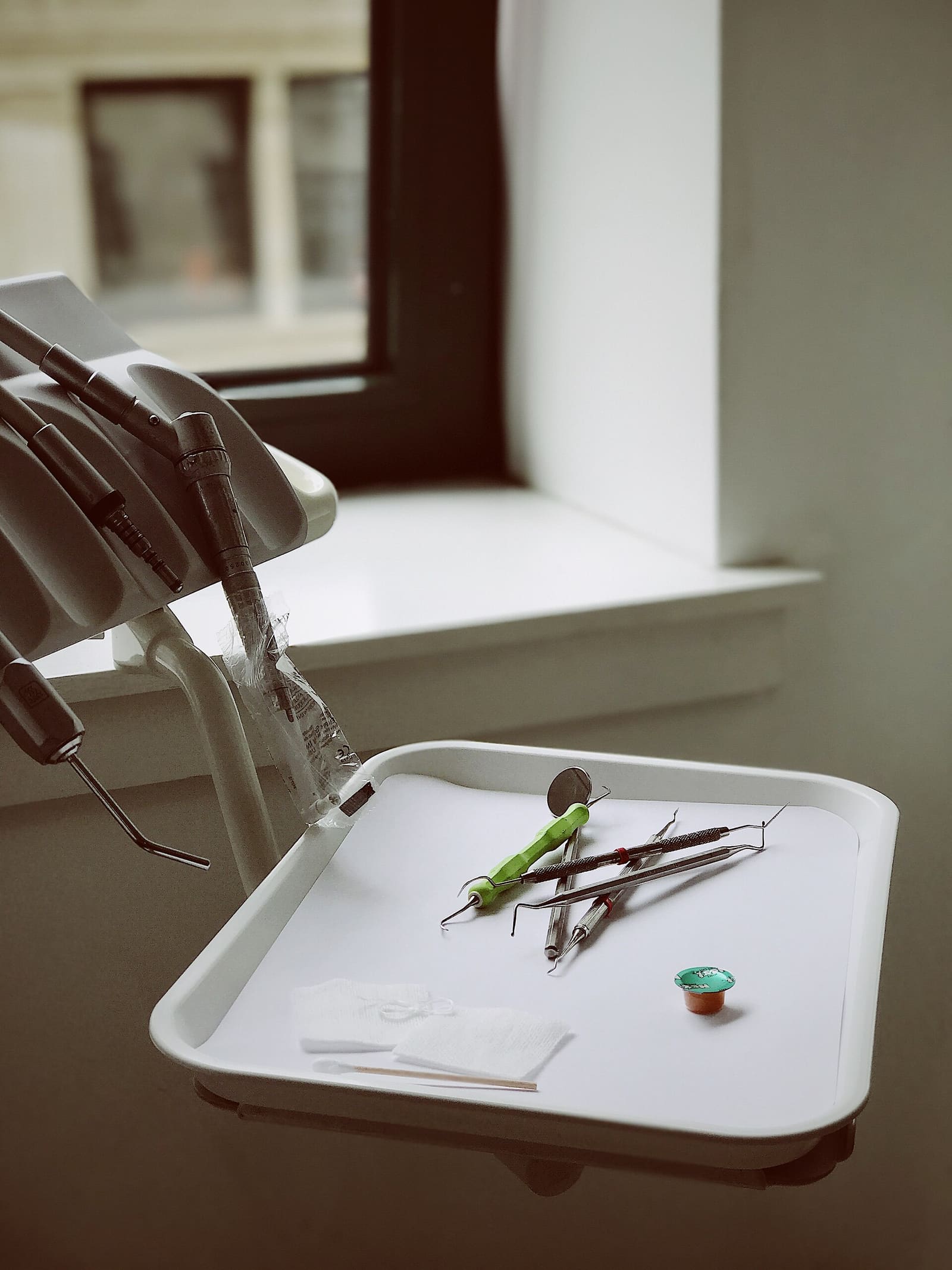 Dental instruments neatly laid out by the window