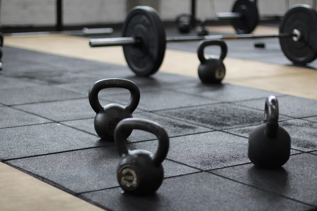 Kettlebells lined up on the studio floor
