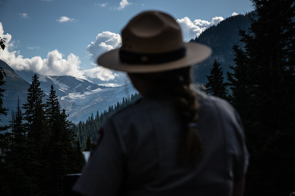 A Park Ranger talks to visitors during the 'Goodbye to the Glaciers' program at Jackson Glacier Over