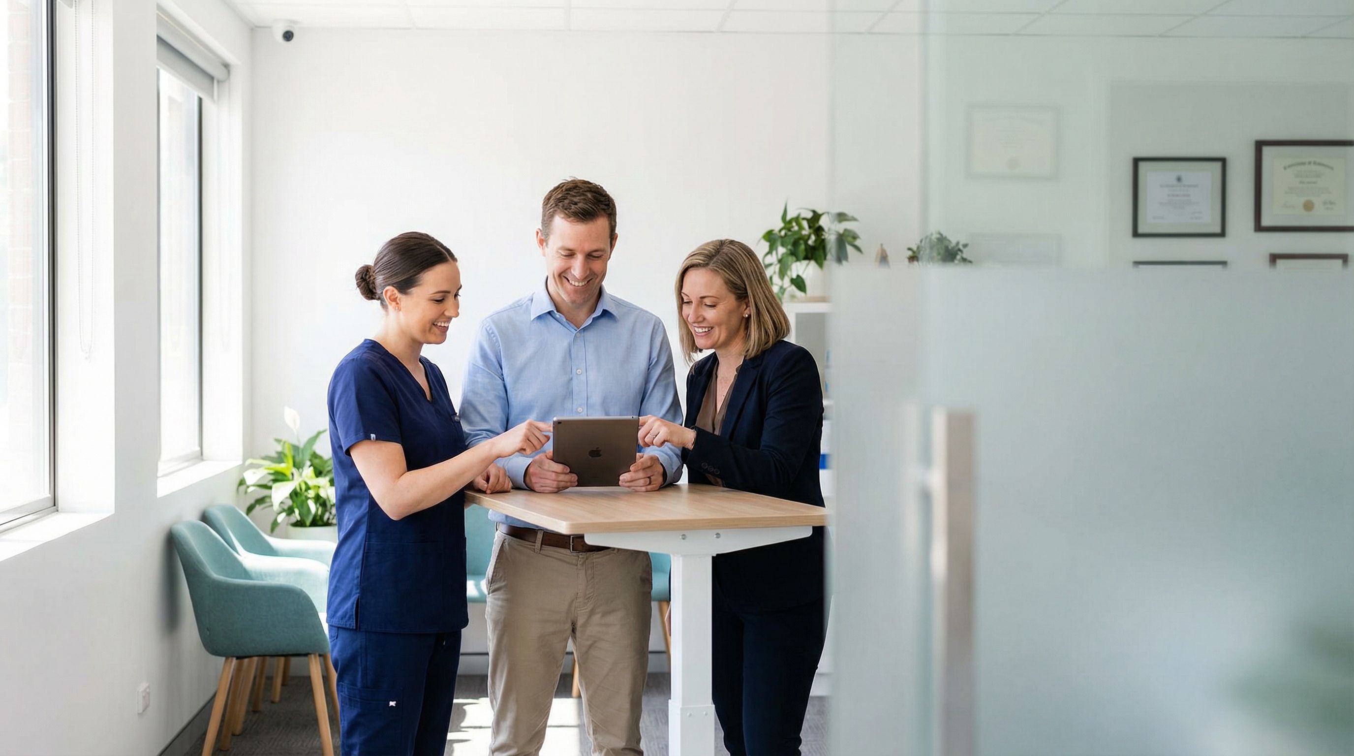 Three ABA professionals at different career levels collaborating in a modern clinic setting