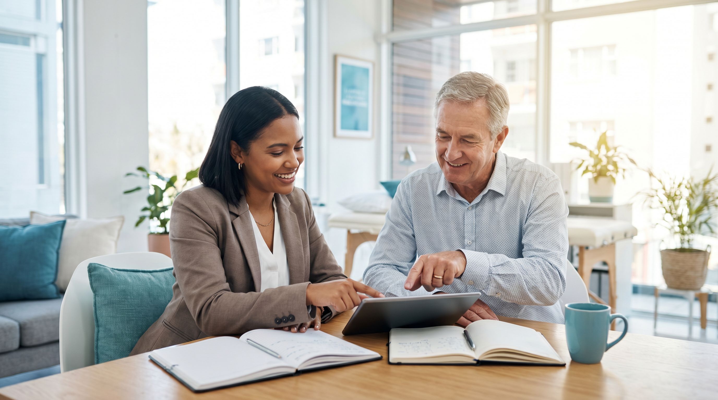 An early-career behavior analyst trainee being mentored by a senior supervisor while reviewing notes