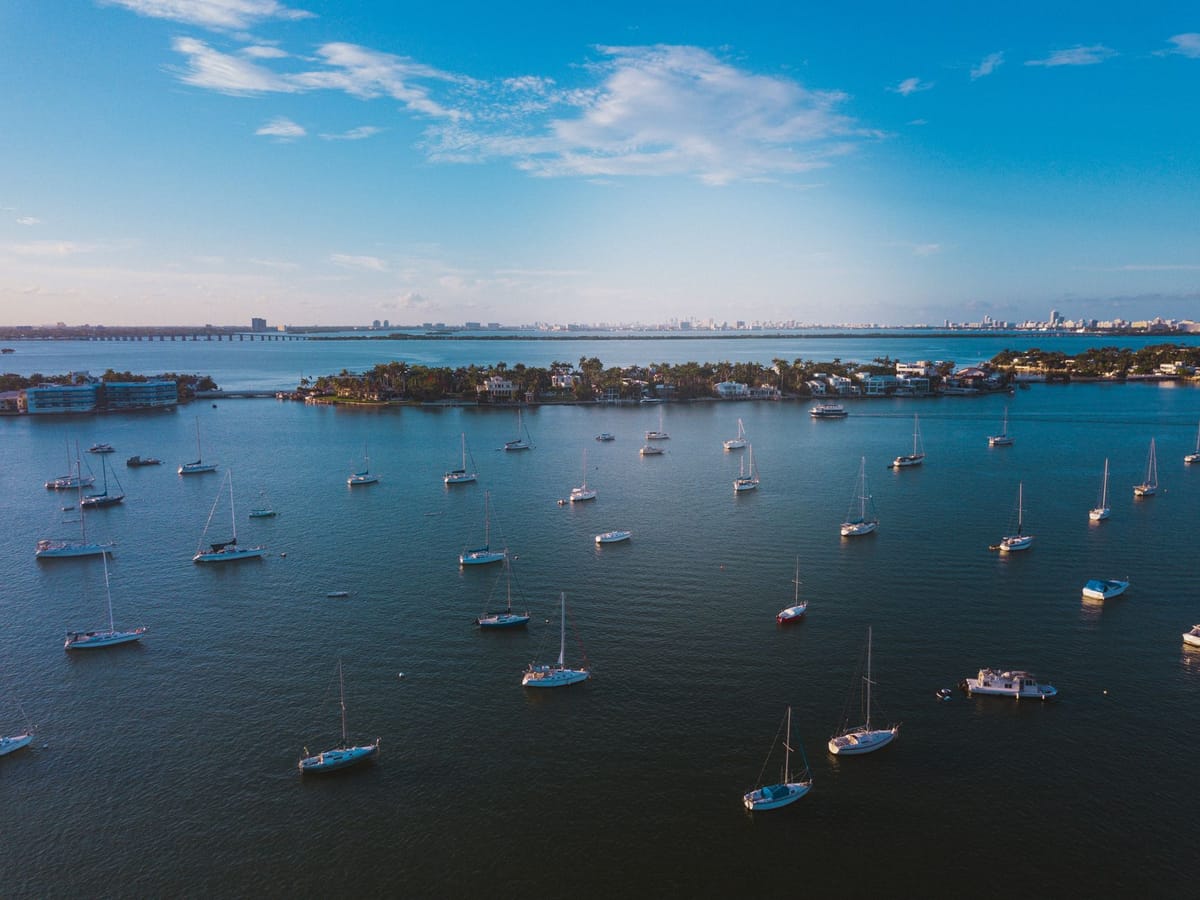 Aerial view of Miami City Marina at Dinner Key with dozens of sailboats docked in Coconut Grove.