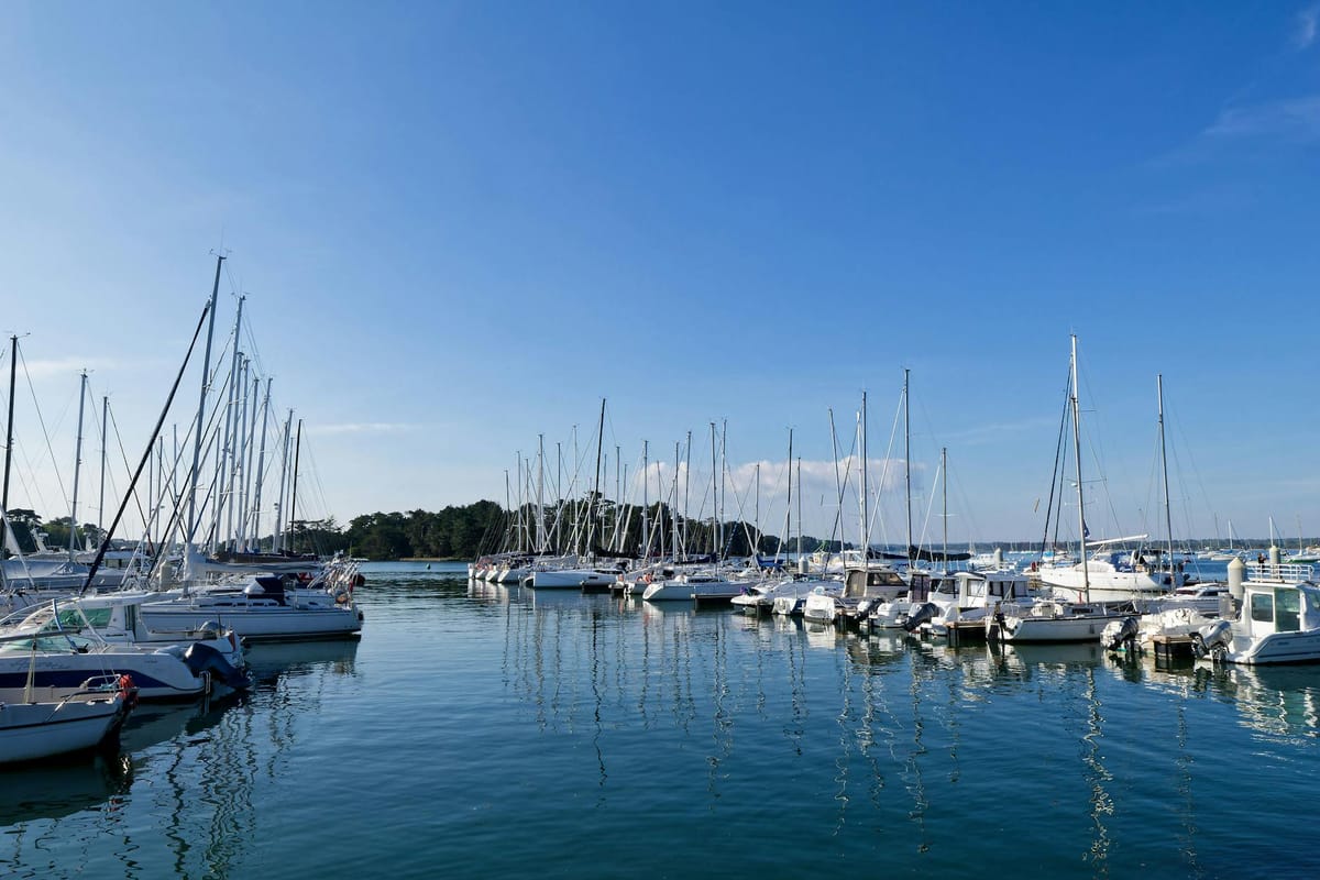 A boat owner reviewing paperwork and charter documents while seated on a marina dock in South Florida.