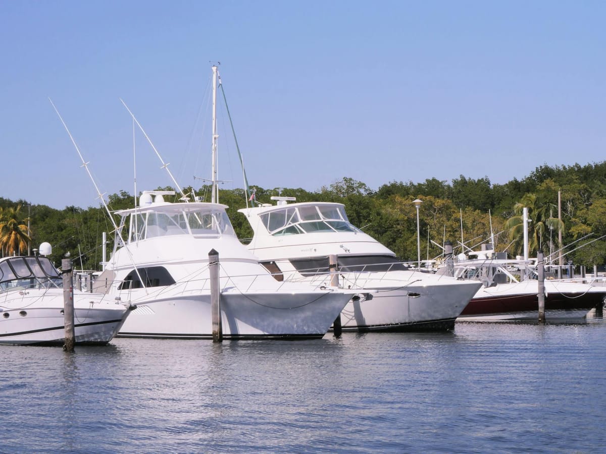 A luxury motor yacht moored along the Hollywood, Florida Intracoastal Waterway on a clear day.