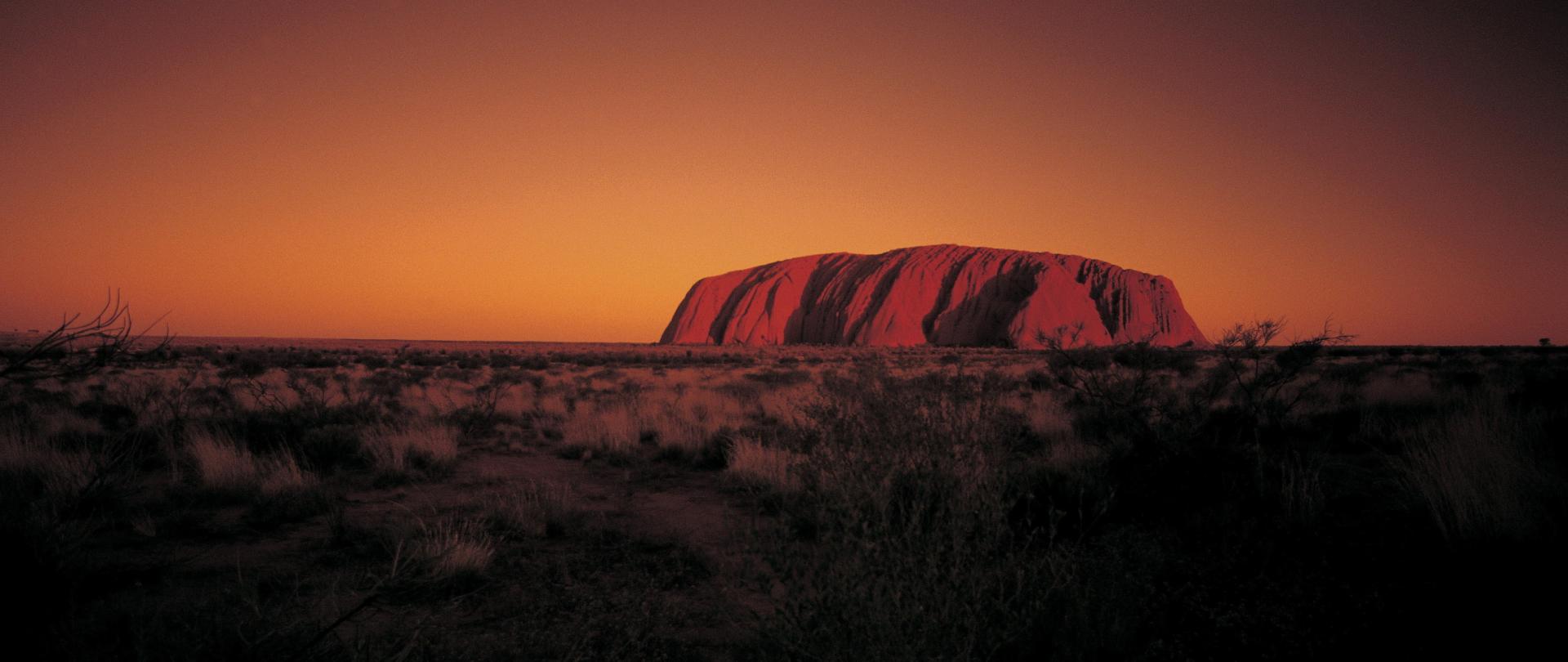 Uluru glowing red at sunset