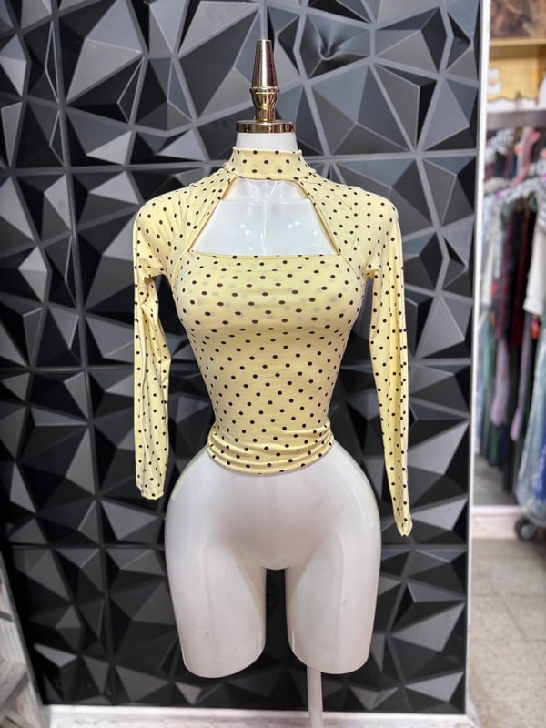 Blusa de lunares con cuello alto, abertura al pecho y manga larga