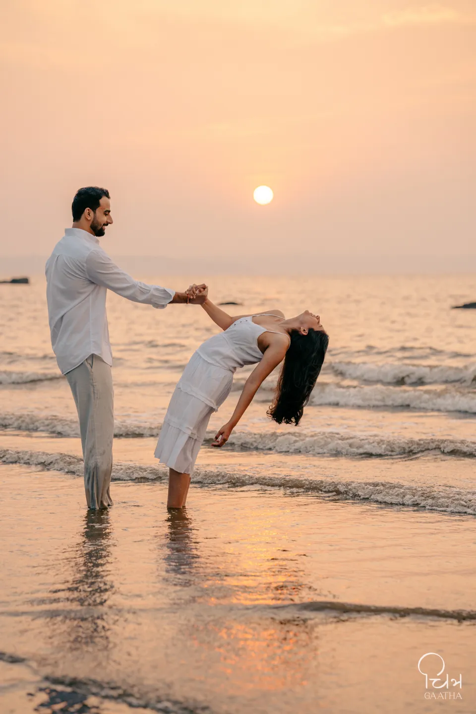 Couple standing by golden water