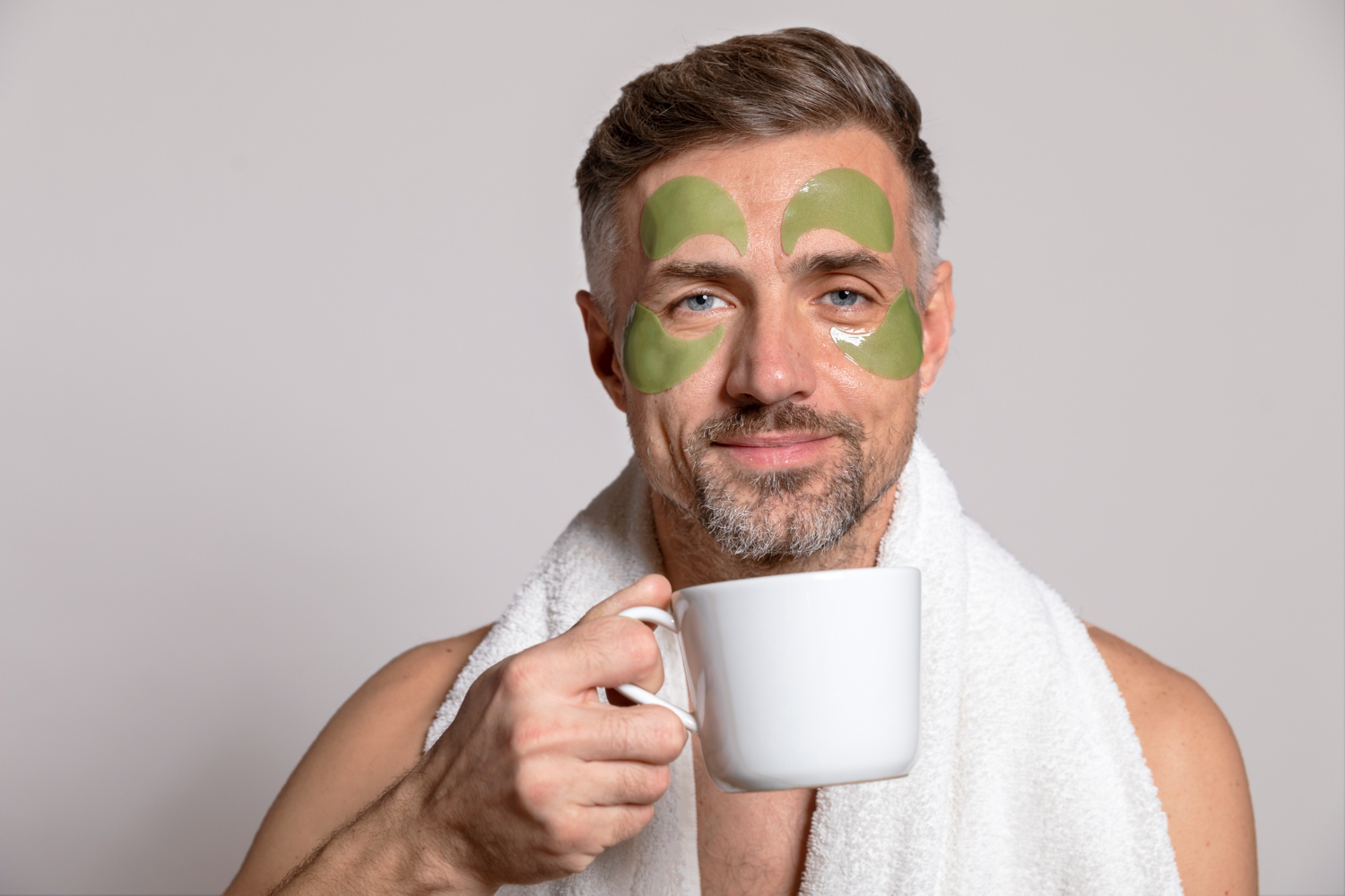 A person applying cold tea bags to their eyes for a soothing effect.