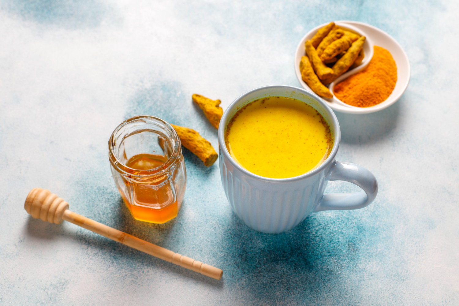 A homemade face mask with yogurt, honey, and turmeric in small bowls.