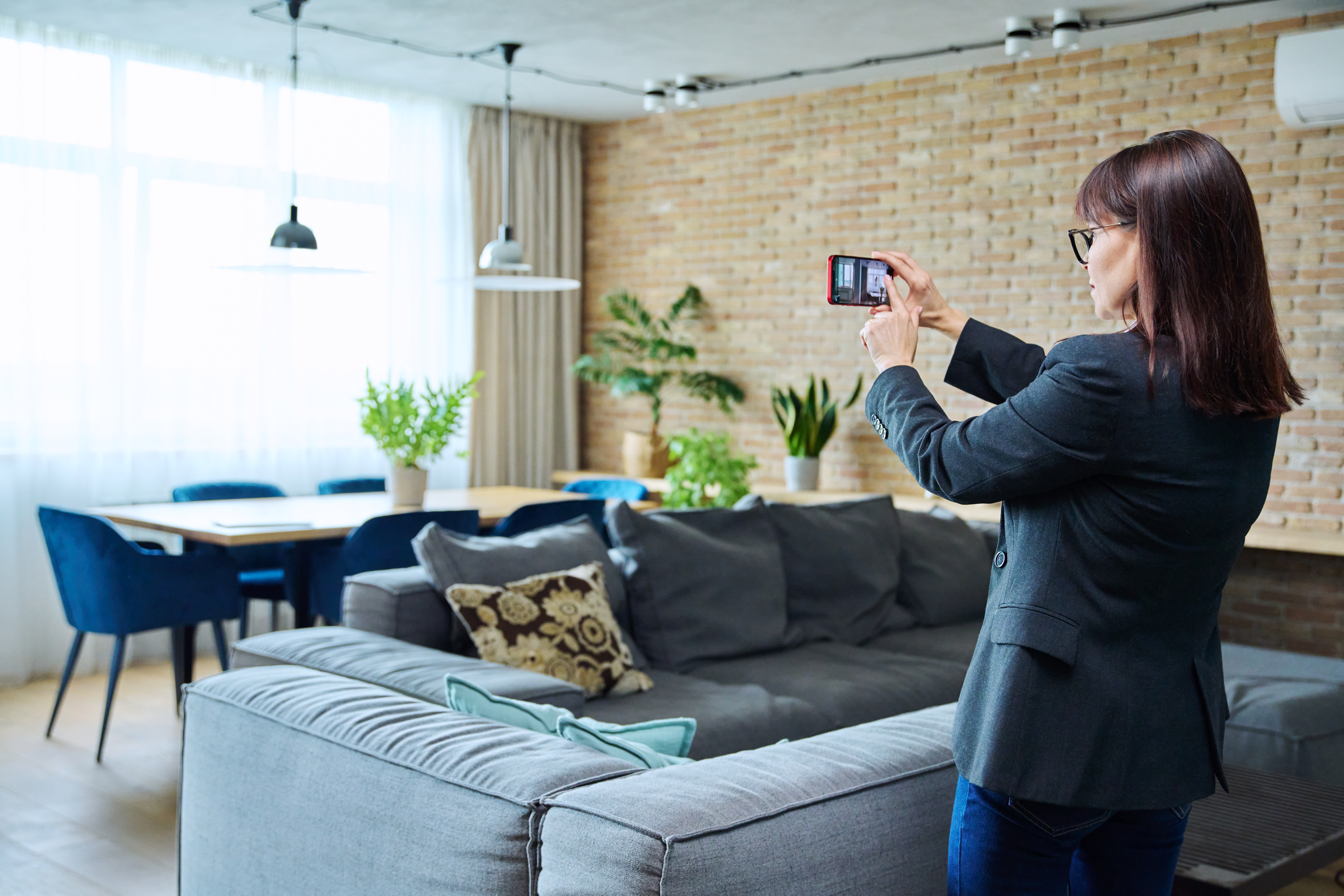 woman-real-estate-agent-photographing-furnished