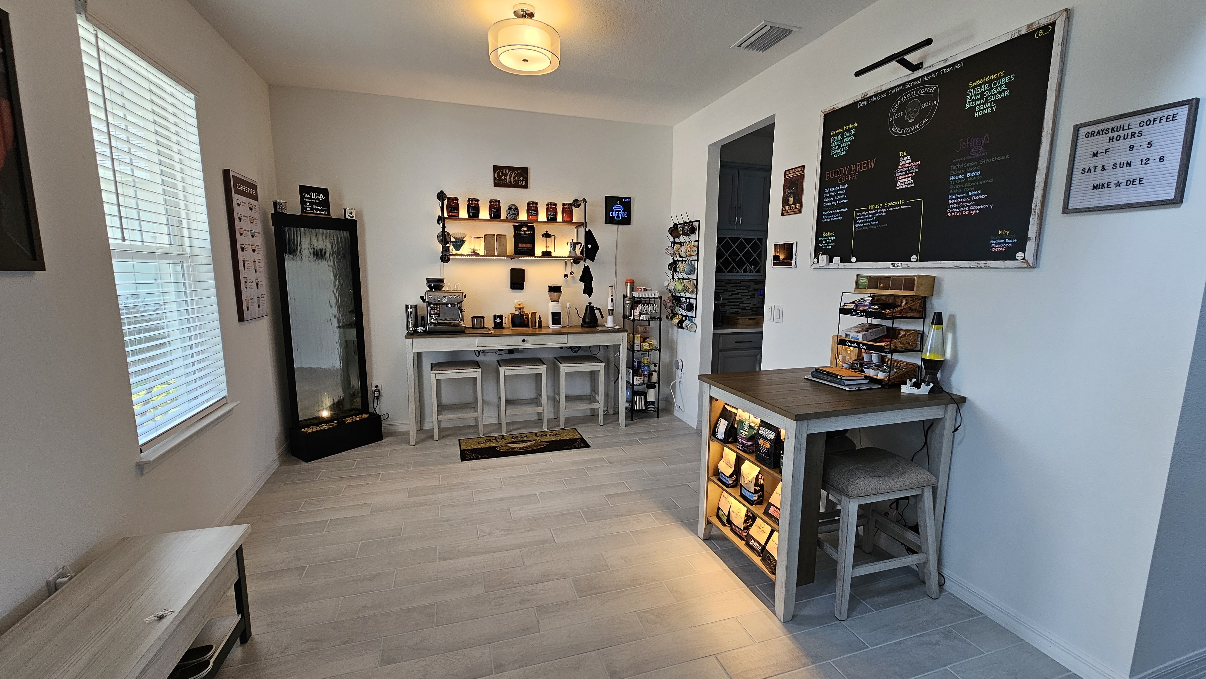 My current coffee bar, I have some ideas to spruce it up including building in some cabinets with a counter top along the back wall, adding a board and batten wall around the room, and maybe a small bar peninsula where that sitting table is currently located. Any other suggestions? What would you do? 