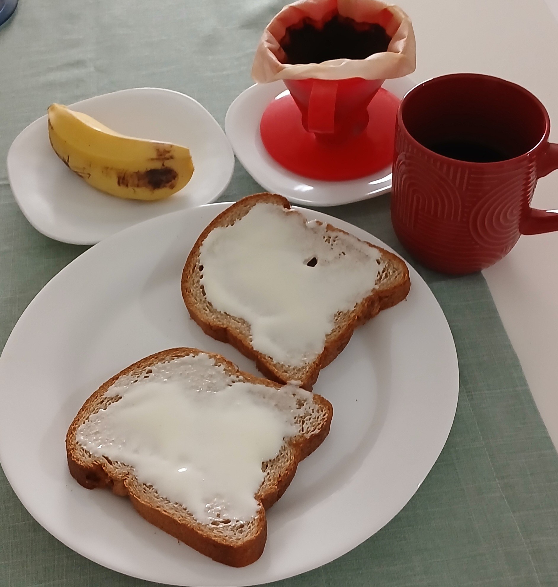 Bom dia! 🌞 Café da manhã com café filtrado na melitta, pão integral com requeijão de búfala e uma bananinha pra fechar. ✨️😋