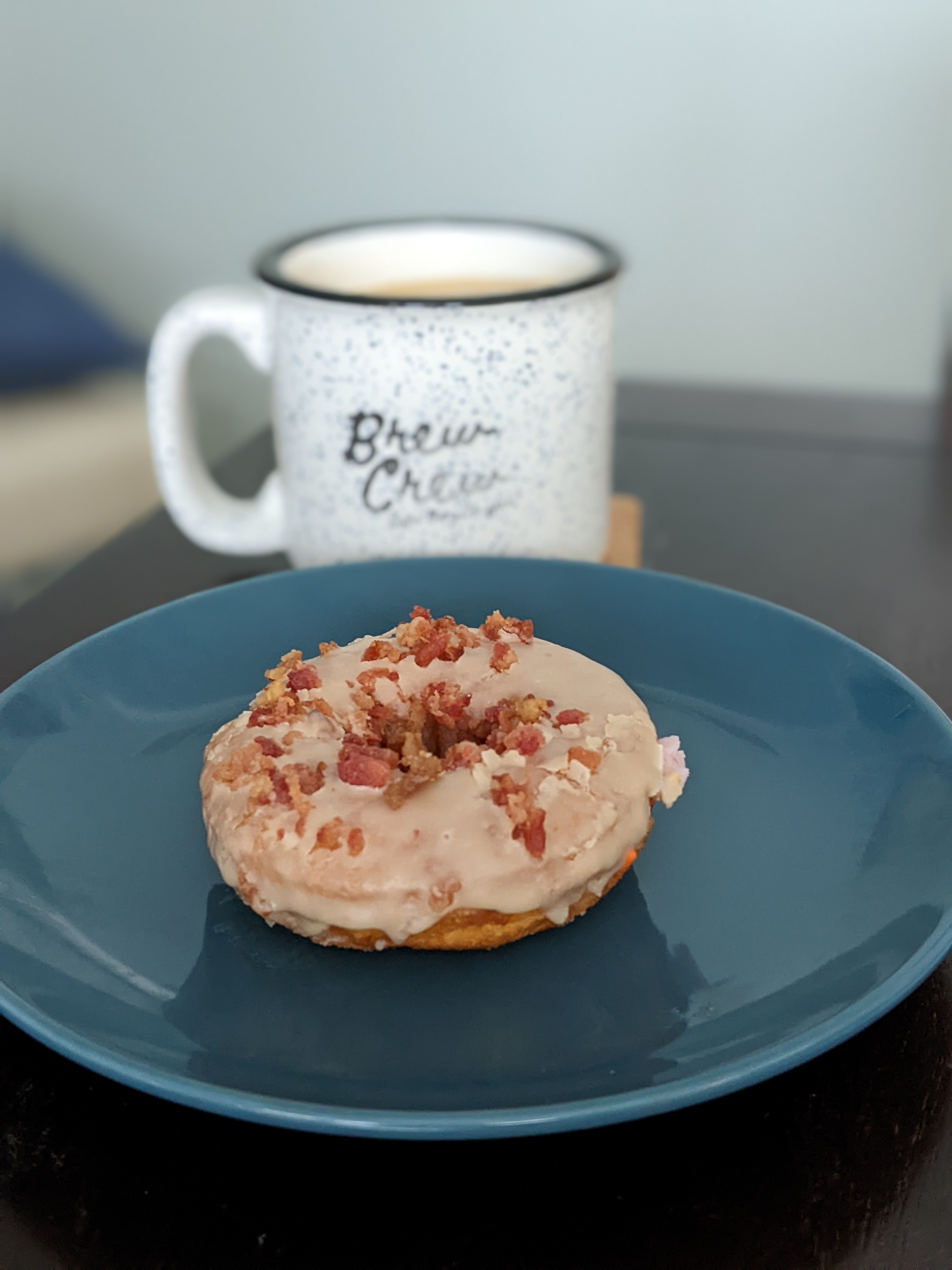 Having a Duck Donut with maple icing, chopped bacon, and salted caramel drizzle with a coffee.  Great combination!!