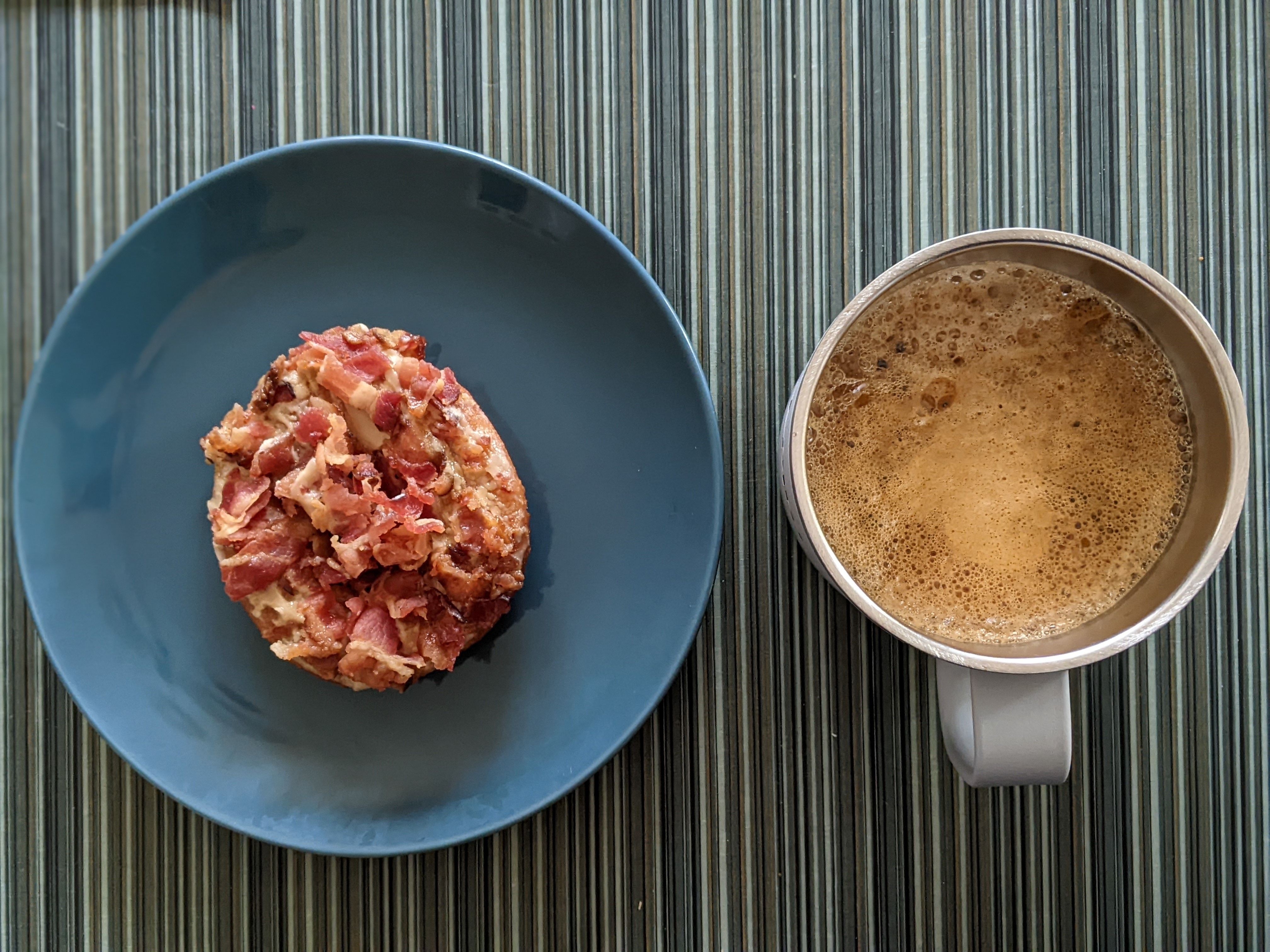 Maple bacon drizzled with caramel sauce on a glazed donut from Duck Donuts pairs well with a roasted hazelnut coffee