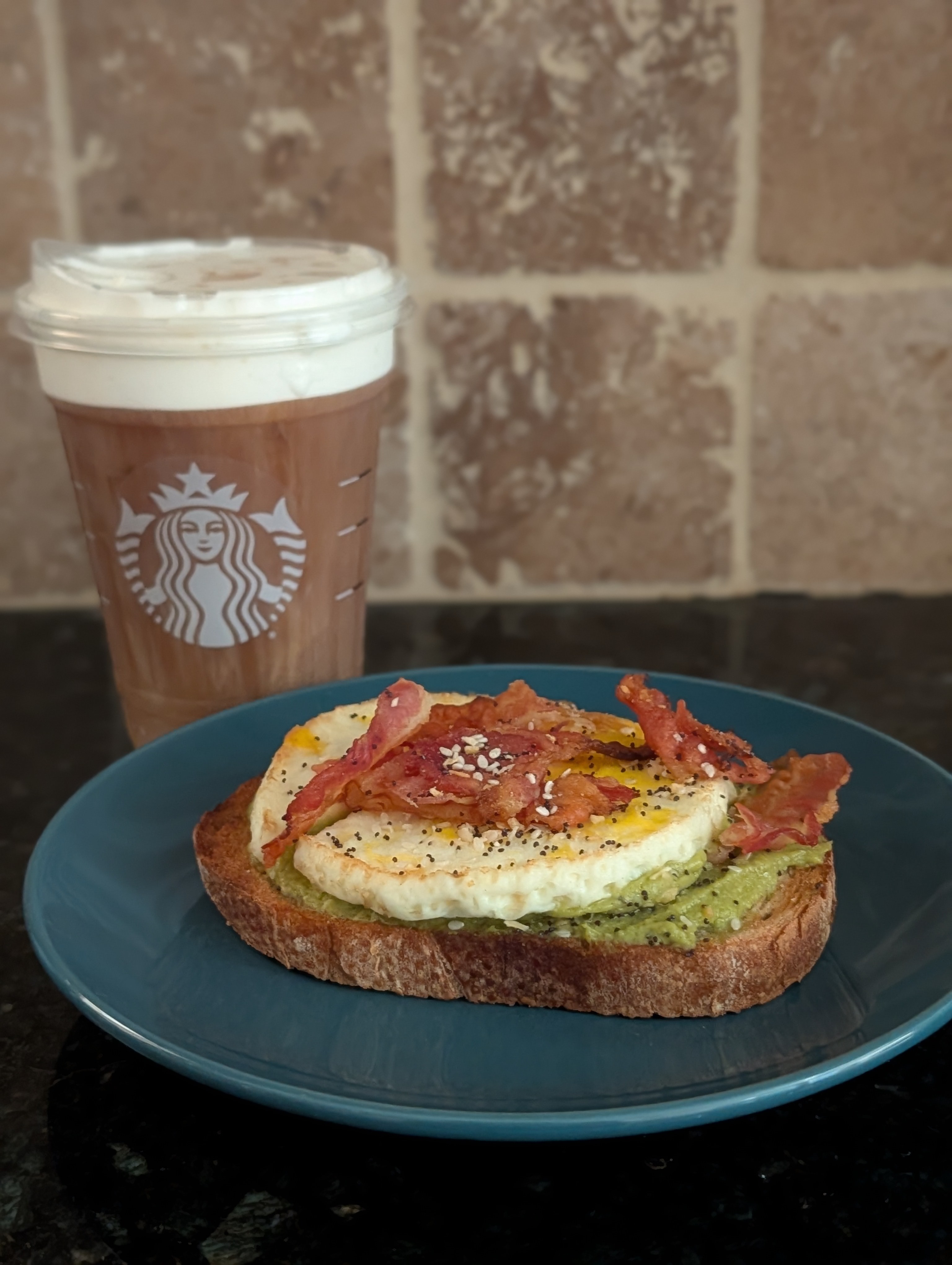 Enjoying an avocado toast with eggs and bacon from Dunkin -- trying something other than donuts :) with toasted coconut cream cold brew on a busy Friday