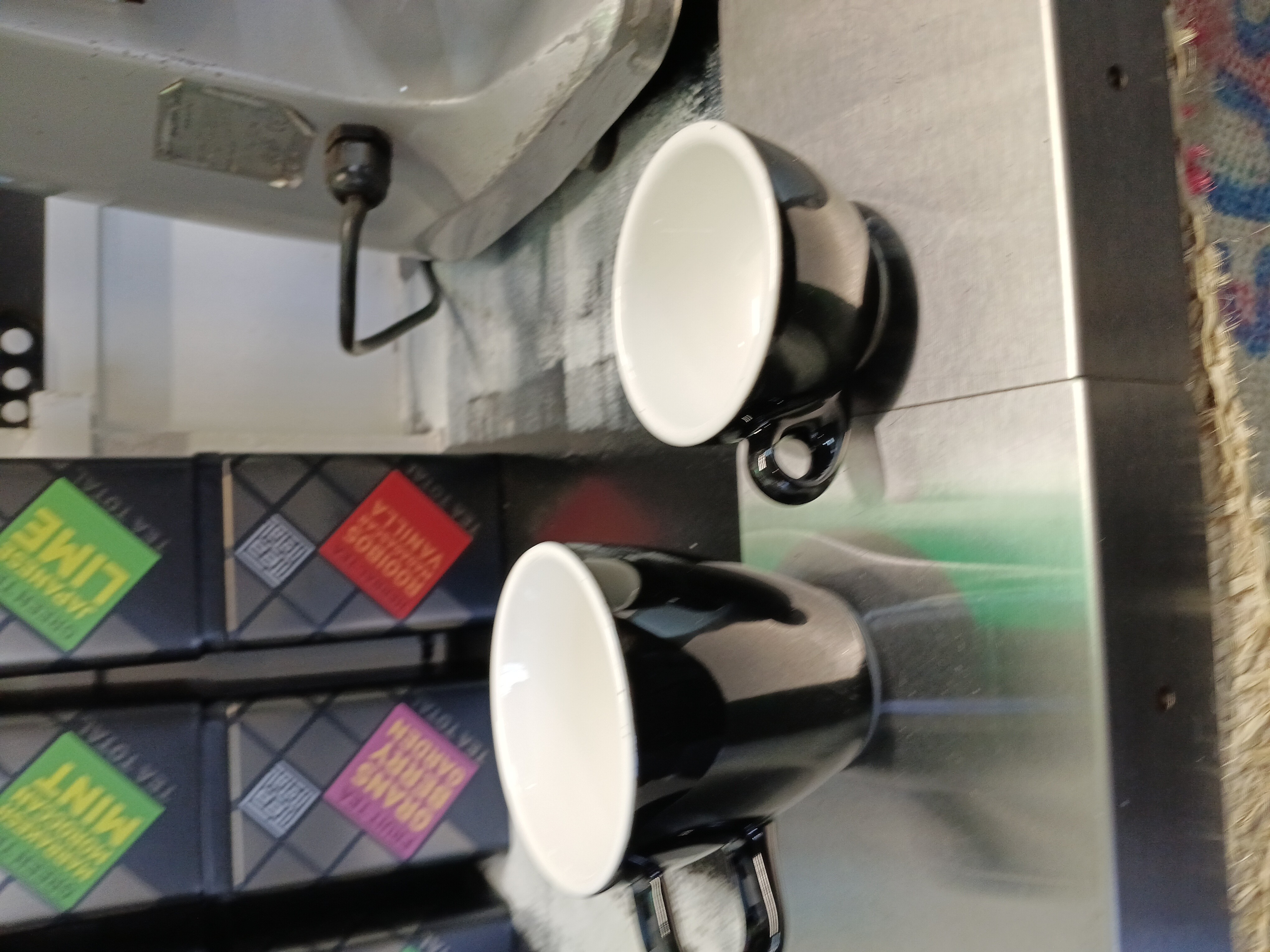 Black-insulated tulip cup, on left is big one, on right is small one which is a espresso cup.