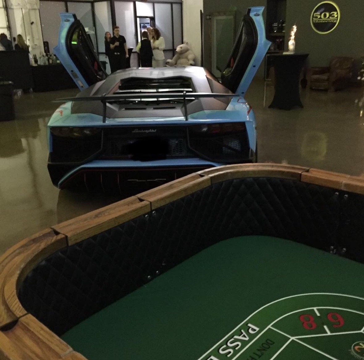drinking my favourite brew at the craps table in a supercar showroom. who does that? 