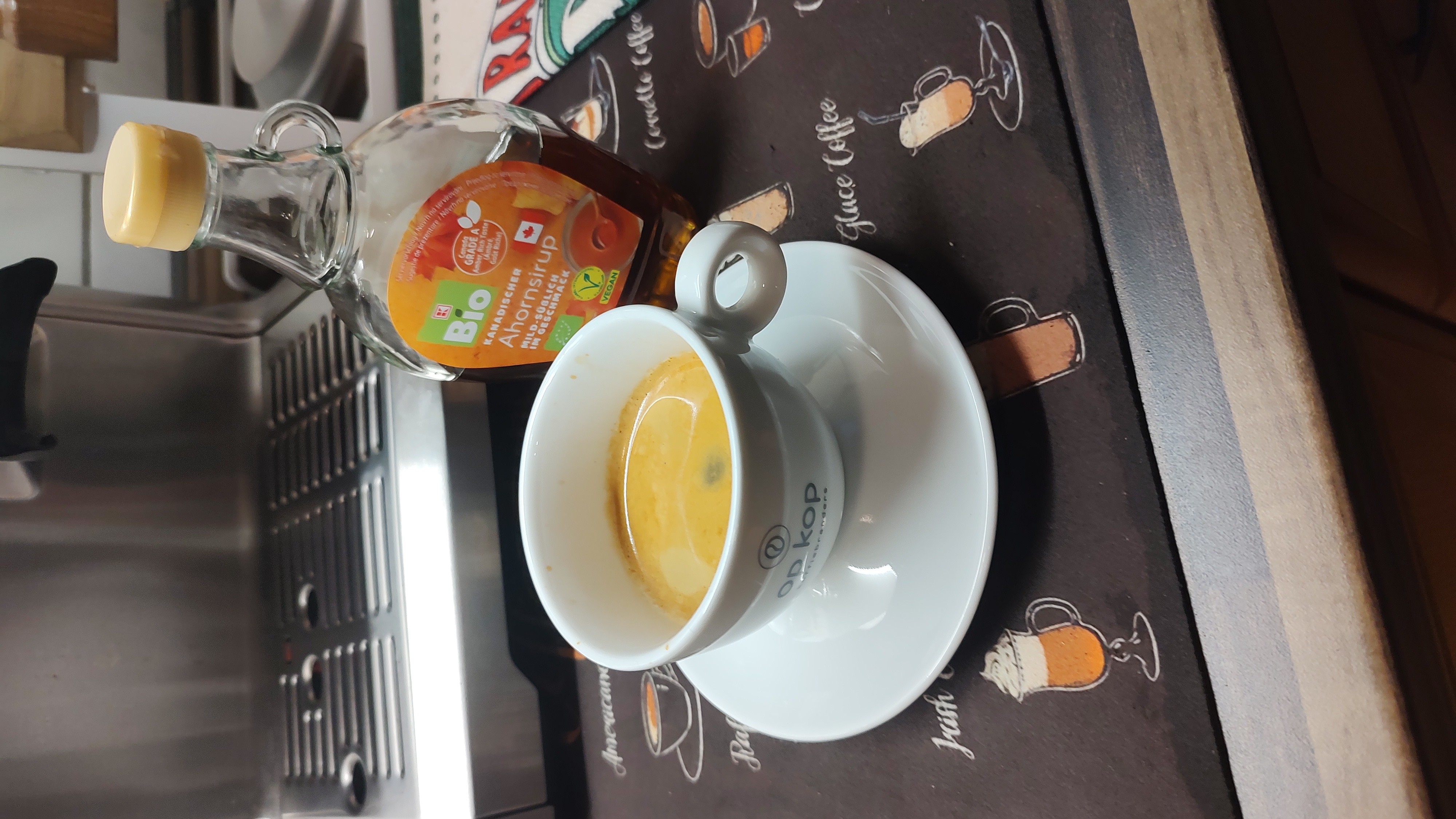 Adding a little sweetness to my espresso with some drops of maple syrup. 