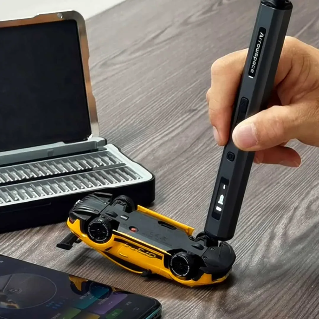 Promotional demonstration image of the S1 being used on a yellow model car beside its bit case.