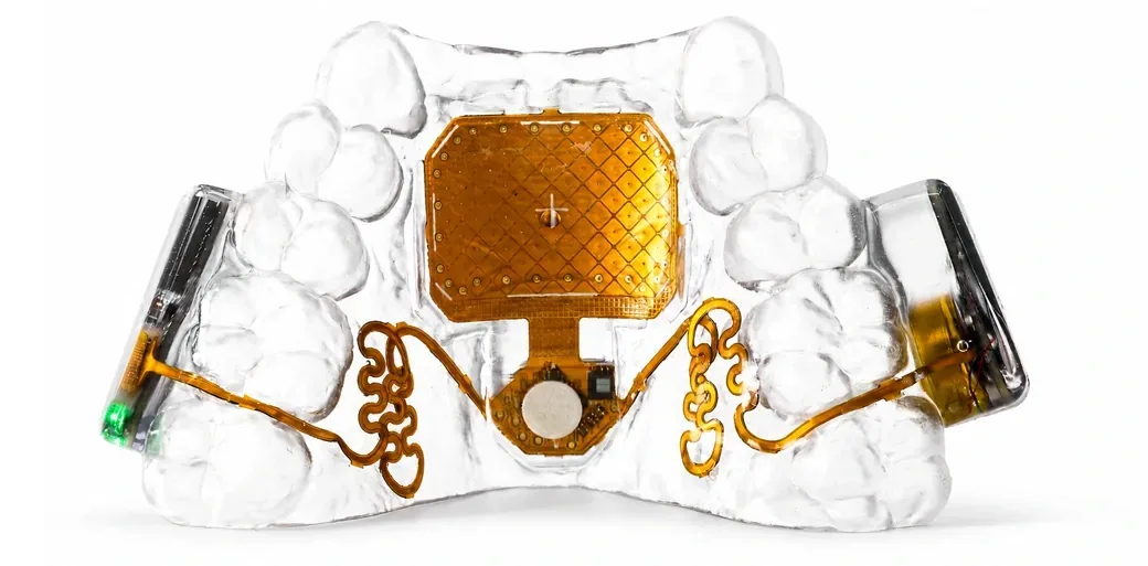 Close-up of the clear MouthPad retainer, gold touch surface, and side electronics.