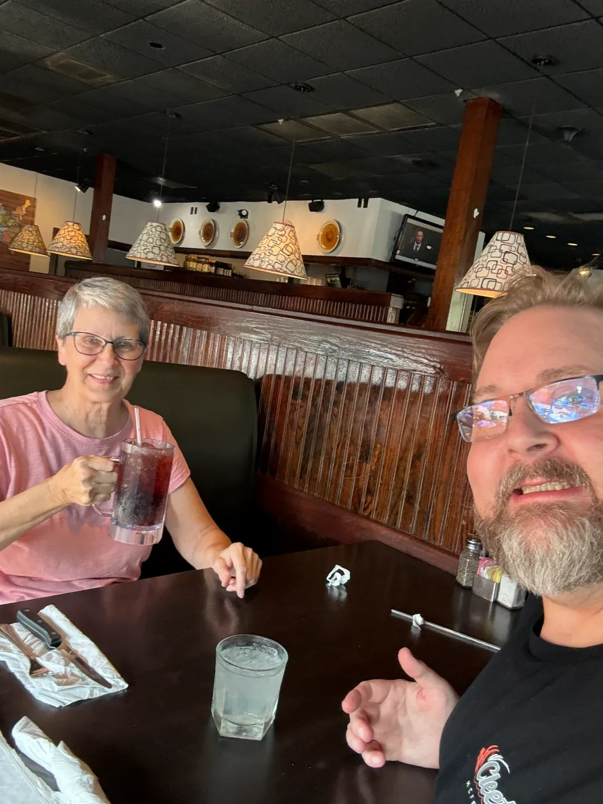 Colin and his mom smiling together during a dinner stop on their three-day drive north.