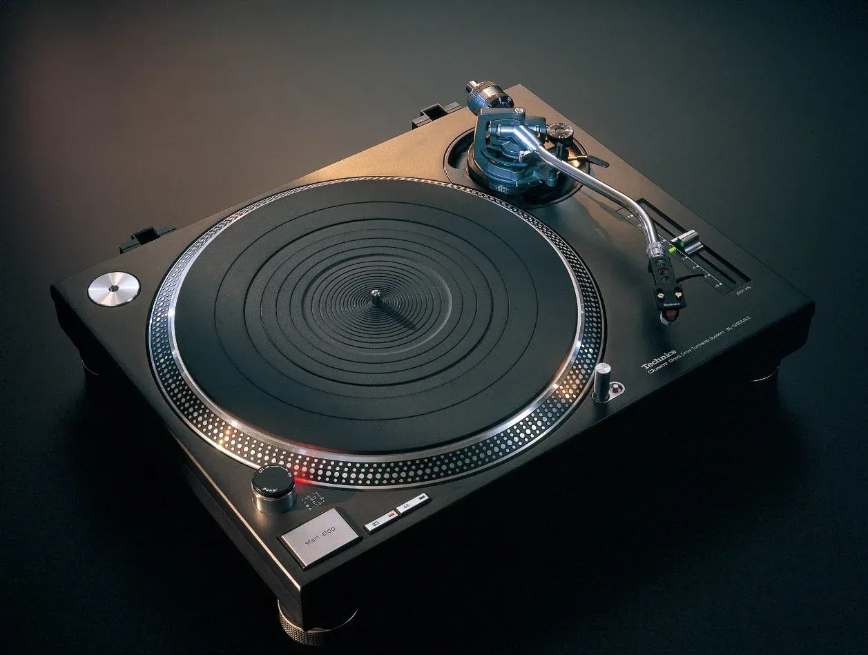 Official historical photograph of the black 1989 Technics SL-1200MK3 with a slipmat, pitch fader, strobe platter and S-shaped tonearm.