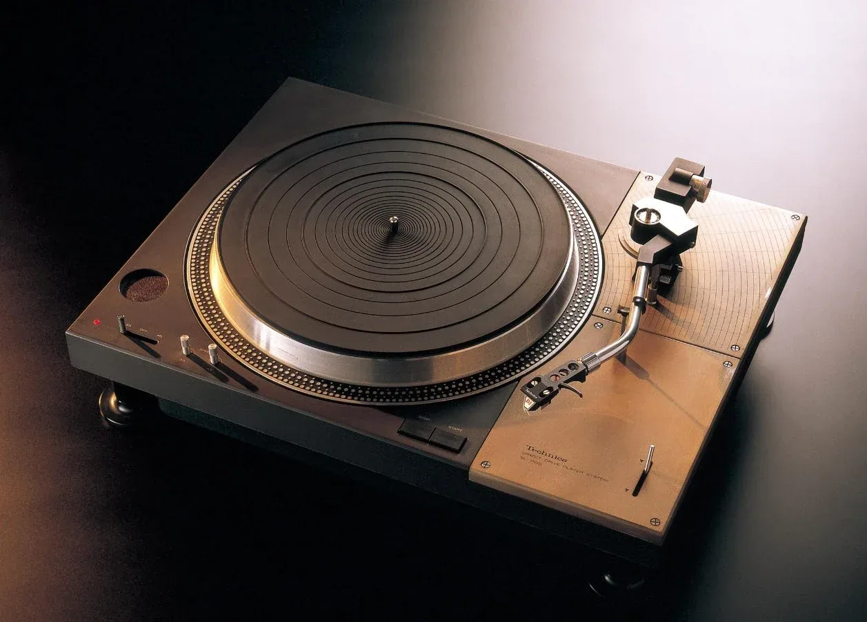 Official historical photograph of the 1971 Technics SL-1100 with its platter and tonearm integrated into one rugged turntable body.