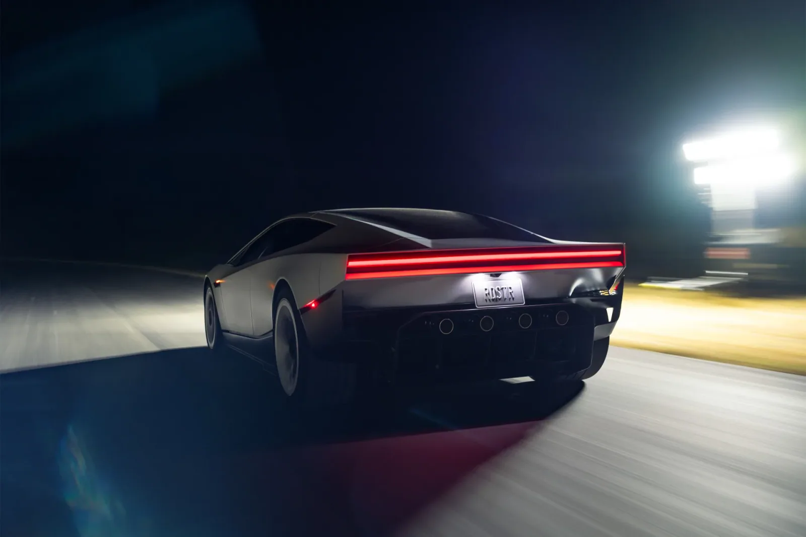 Rear three-quarter view in Tesla’s night-driving imagery.