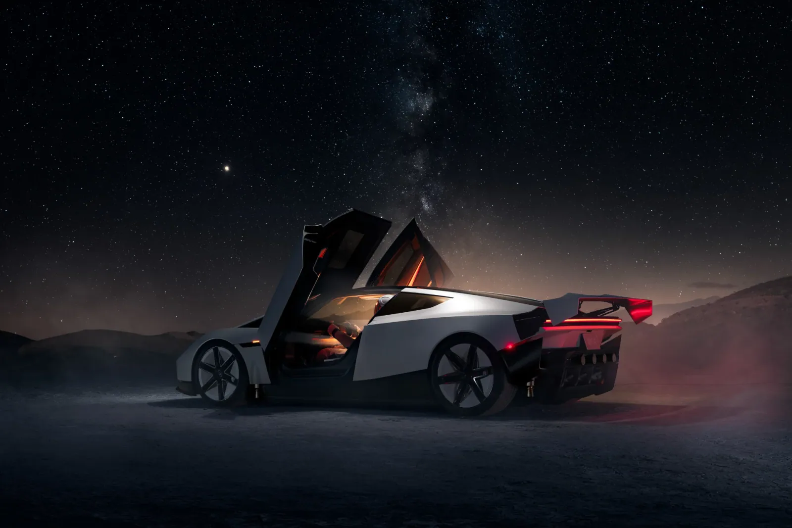 Roadster with its doors raised beneath a star-filled night sky.