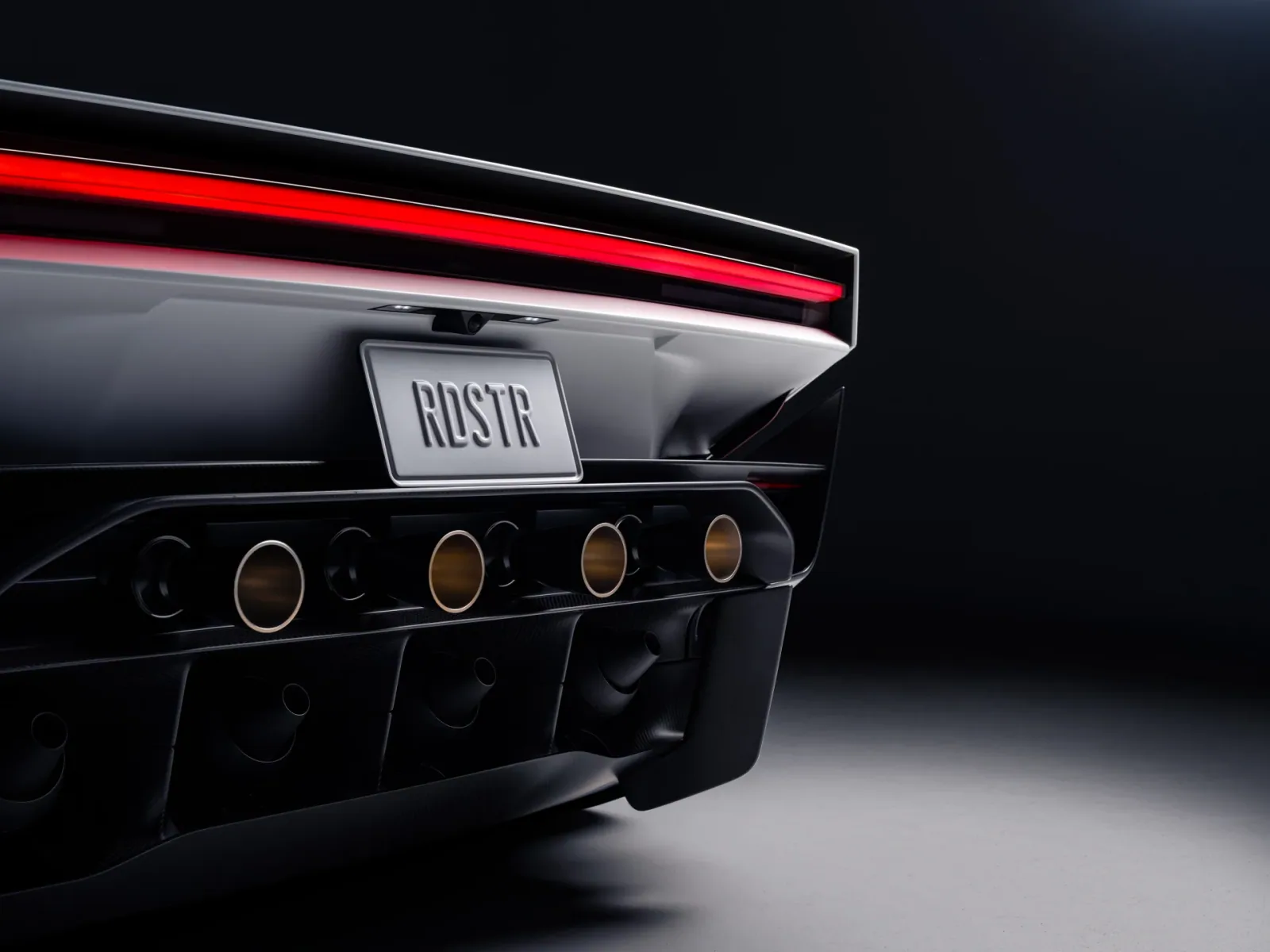 Close-up of the rear light bar and four circular rear outlets.
